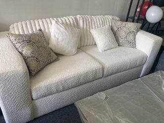 2 seater Ashley Furniture Chessington sofa featuring plush ivory upholstery and a textured, corded backrest