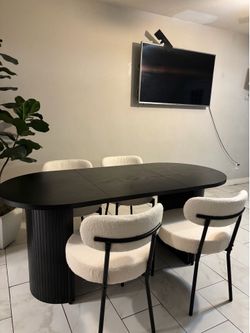 Long black fluted dining table with chairs