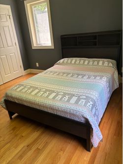 Full size bed with drawers, desk, and nightstand