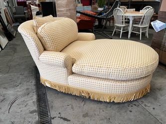 Victorian-style chaise lounge features gold circle and white upholstery pattern