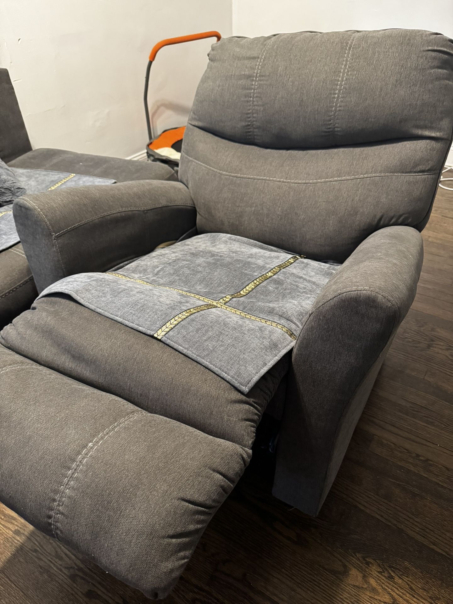 Grey rocking recliner chair that you can use for sleeping