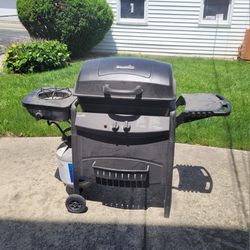 2 BURNER PROPANE GAS BBQ GRILL WITH SIDE BURNER AND SIDE WORKING SHELVE. IT INCLUDES ONE  COVER AND ONE EMPTY PROPANE TANK.. $125.00 OR BEST OFFER. 