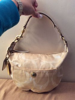 Cream colored small coach hobo bag
