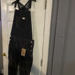 Dark blue denim overalls with front pocket and button details. $120 Location Mount Dora Fla 32757