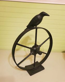 Large Farmhouse iron wagon wheel with a Crow on it