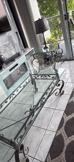 3-piece living room set. Rectangular coffee table + two matching end tables. Designed w/clear glass tops & metal frames with decorative scrollwork det