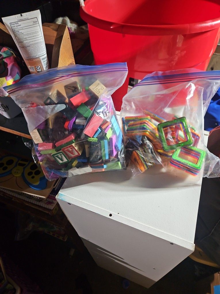 Wooden Blocks And Shapes And Plastic Squares That Make Cubes