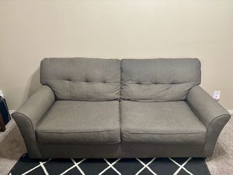 Ashley Stationary sofa in chocolate color