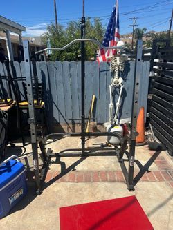 RockFit 435 Squat Rack with Lat Pulldown  Sturdy black and silver steel RockFit 435 squat rack. This unit has a built-in lat pulldown attachment with 