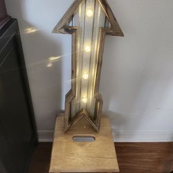 luminous arrow made of wood and metal
