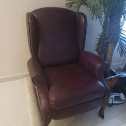 Brown leather wing back chair