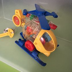 Wind-up Helicopter. Top Propellers Spins And Toy Moves Across Floor