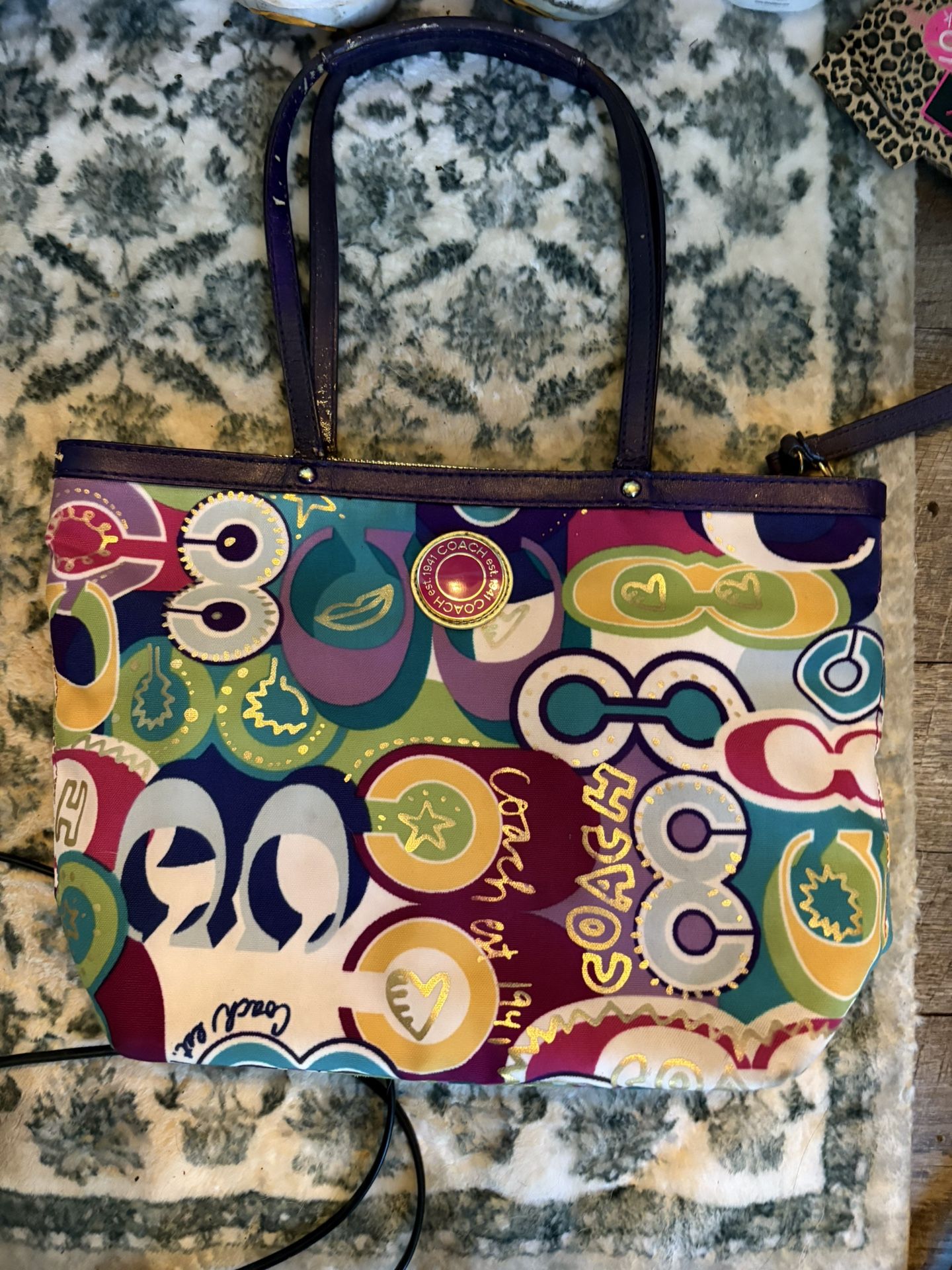 +4 This is a Coach Poppy Tote with a multicolor graffiti print.