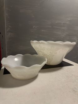 milk glass mixing bowls with a grape-and-leaf pattern and scalloped rims,