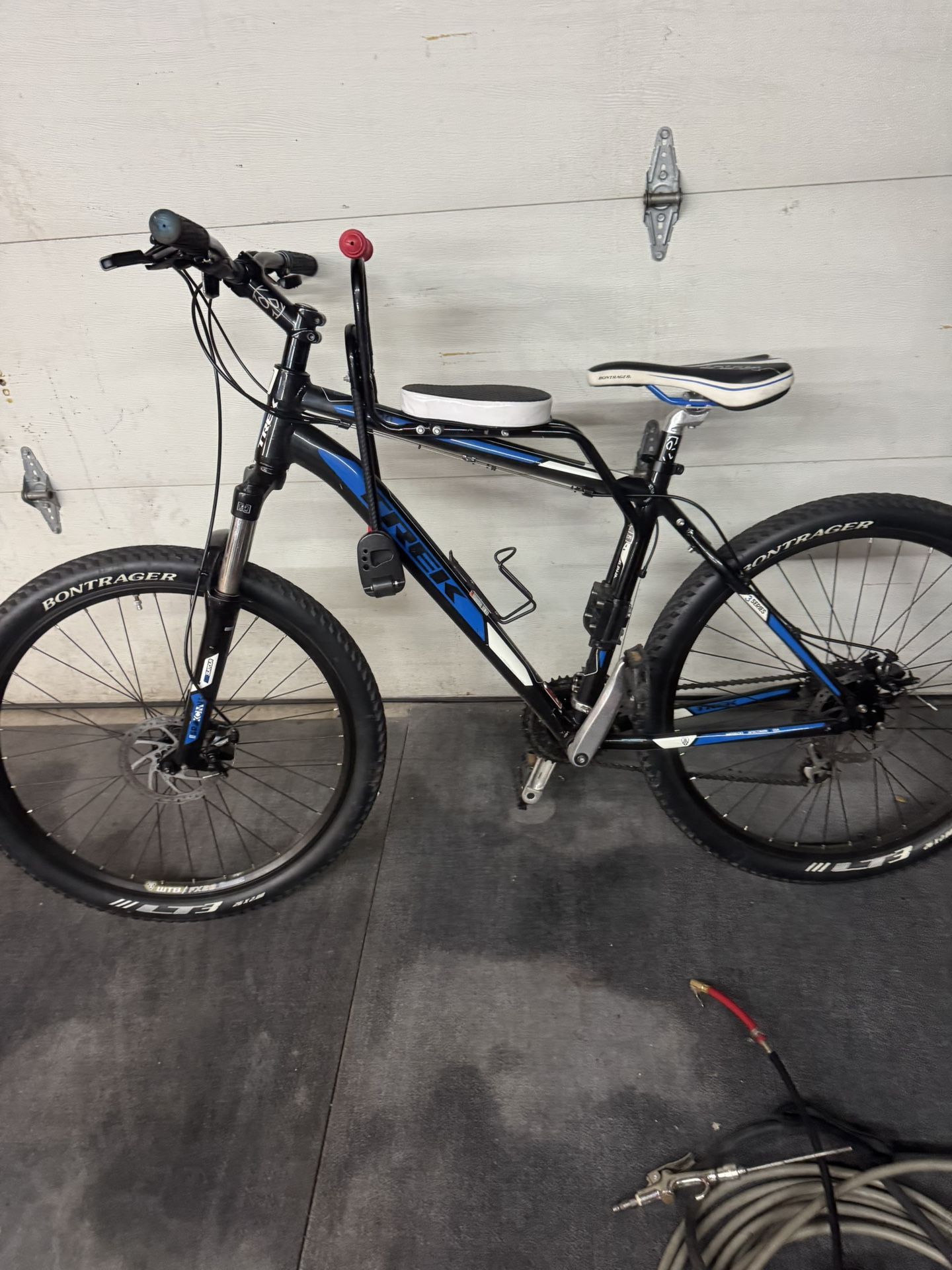 Trek 3700 mountain bike with a child seat attached to the frame.