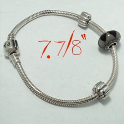 1 Pandora 7.7/8” bracelet with 1 charm and 2 clips