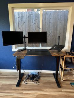 Electric standing or sitting desk in great condition. Monitors not included.