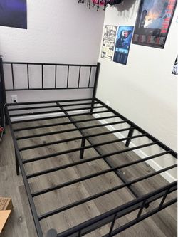 Black metal bed frame with headboard