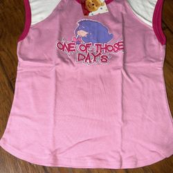 A pink and white Disney-themed apparel top featuring Eeyore and the text "ONE OF THOSE DAYS Large on tag
