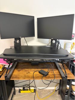 Flexispot height adjustable desk converter WITH desk and 2 computer monitors.