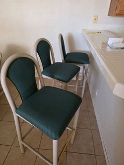 Three green bar stools