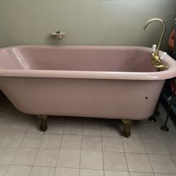 1929 cast iron clawfoot tub with brass feet and faucet