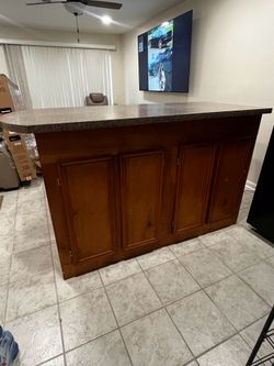 Hard top wooden bar with cabinets