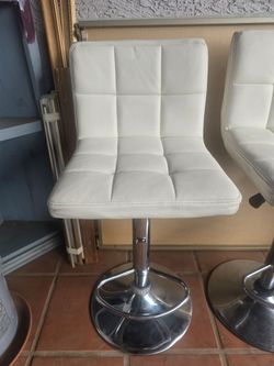 "REDUCEDPRICE" (4) White leather bar stools in "used" condition.