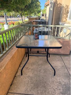 Patio table with chairs and umbrella