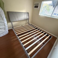 Upholstered grey bed frame and headboard 