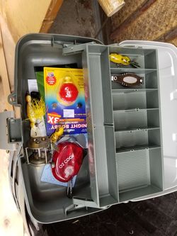 Tackle box with some lures and antique reel