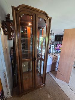 Tall Oak curio Cabinet with beveled glass doors, light and 4 glass shelves