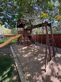 Wooden swing set with slide and picnic table