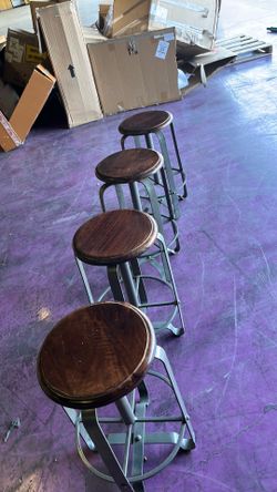 Four swivel wood top steel frame barstools