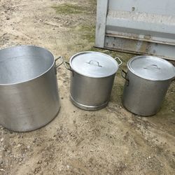 Three commercial stock pots two with lids one without