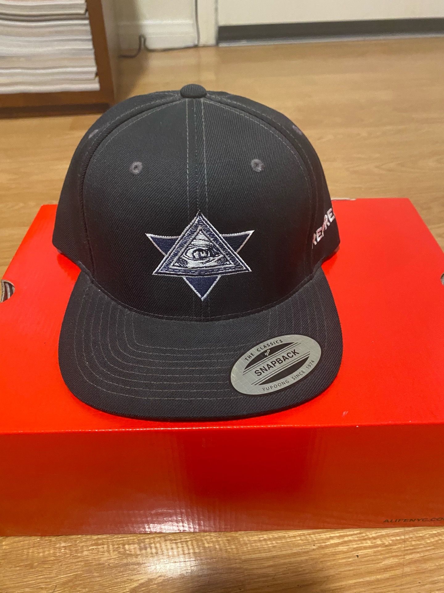 Black Yupoong snapback cap
