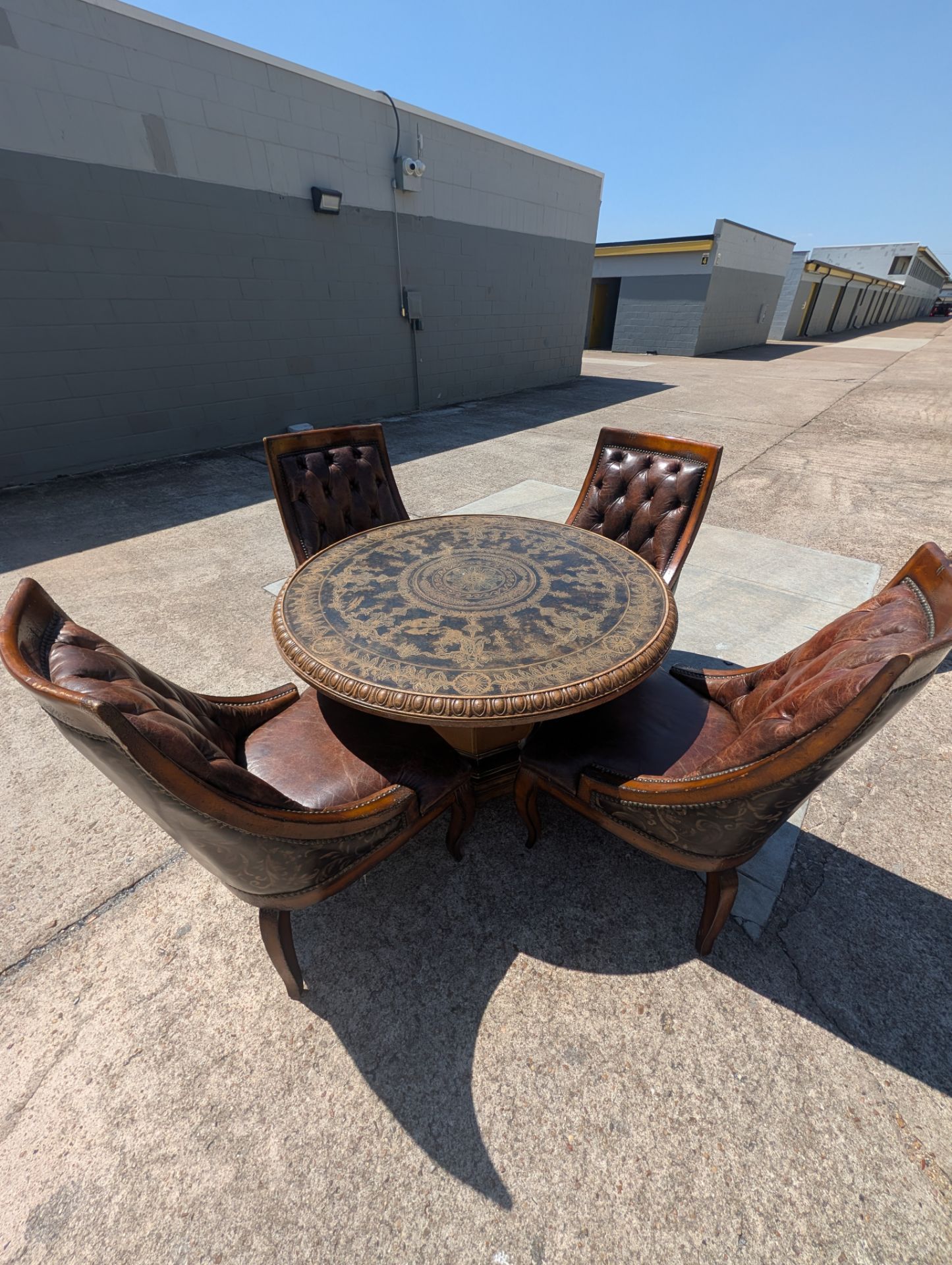 Round dining table with 4 leather chairs. 50 in wide 30.5 in tall