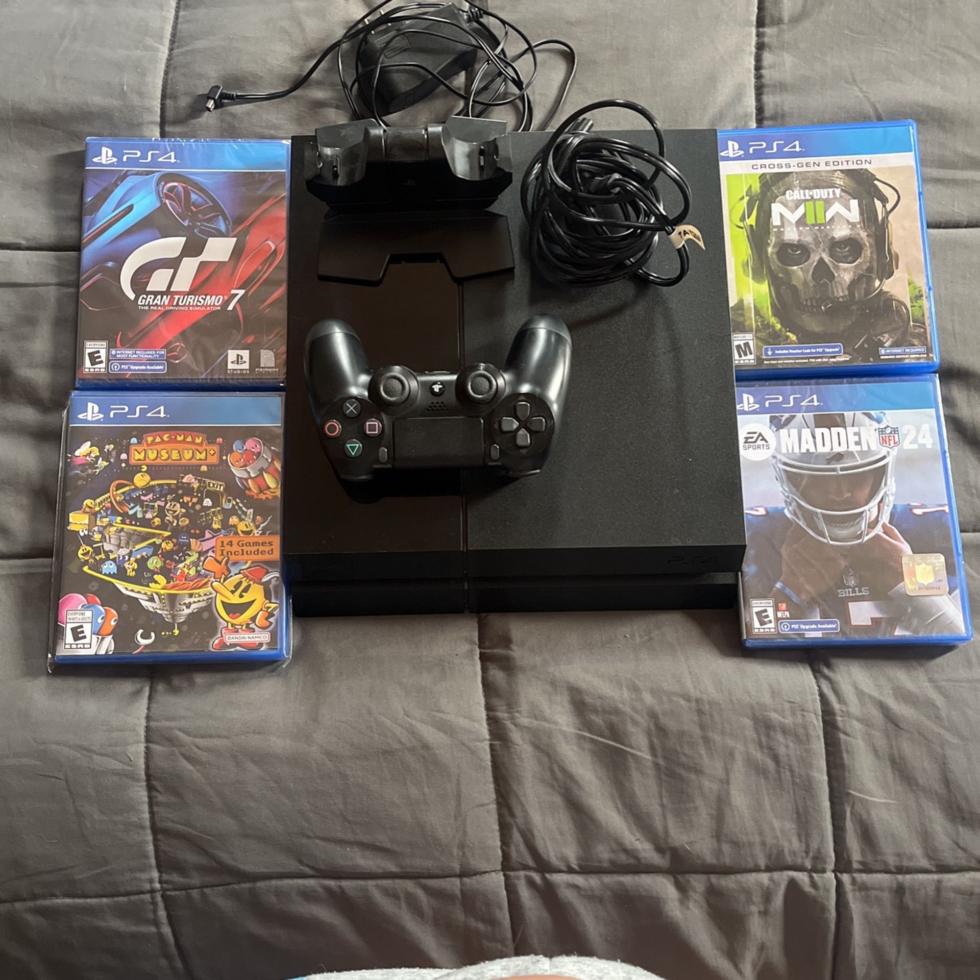 PS4 + Controller + 4 New Games + Charging Station