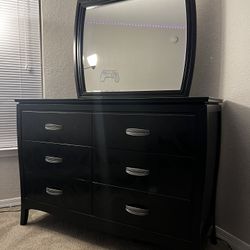 Black dresser with a mirror