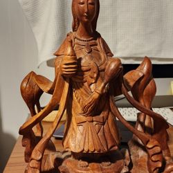 hand carved solid wood statue. 12x9x4