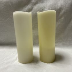Two white 12 inch tall flameless battery operated pillar candles 