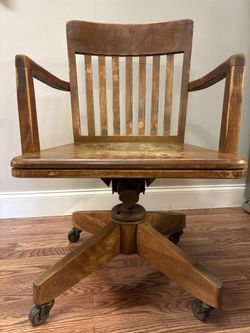 Antique Executive hardwood Walnut rolling chair.