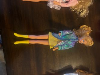Vintage Barbie doll has blonde hair and blue eyes