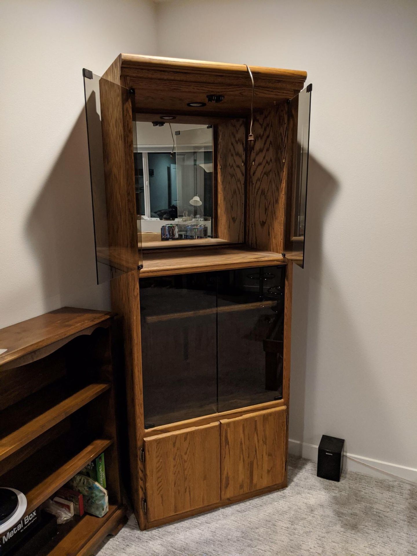 Solid wood, lighted glass cabinet we used it as a liquor cabinet.