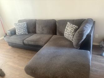 Living room Sofa. PICK UP ONLY. Like new other than the small stain in the picture. Will include TV stand for $225