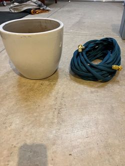 Garden Hose and Large White Planter Pot