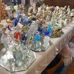 Table Of Collectibles. Fitz And Floyd, Lennox, Murano, and figurines. See all pictures inquire if interested. Various prices.
