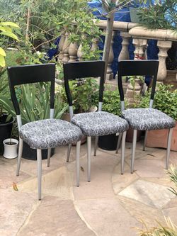 3 black and silver chairs