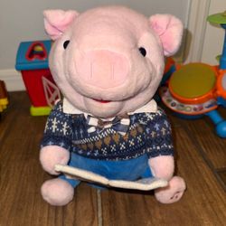 Plush Pig Toy with Blue Sweater reads story 