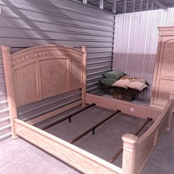 Homestead House King wood bed frame with decorative headboard and armoire